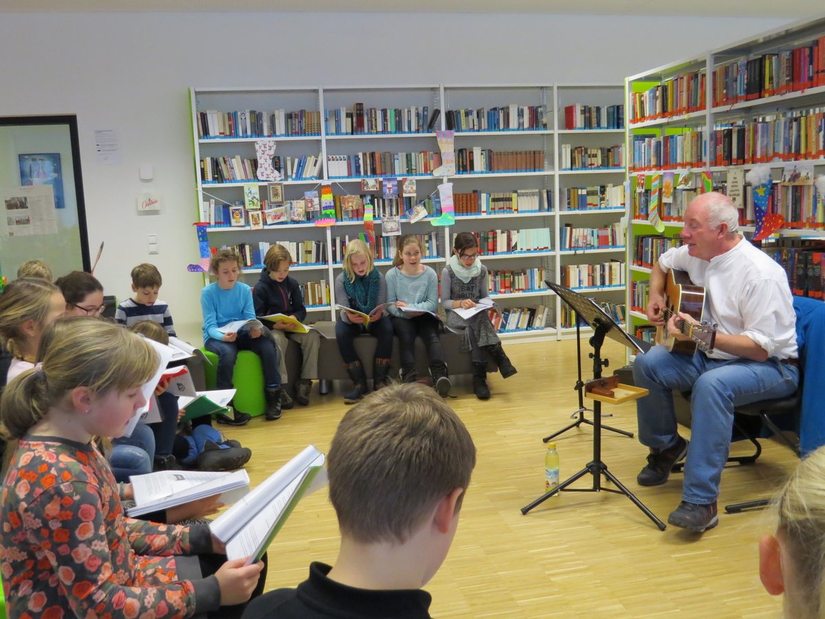 Wie immer ging es vorweihnachtlich-fröhlich und besinnlich in unserer Schulbibliothek zu, als Martin Fowles mit unseren Fünftklässlern international bekannte englische Weihnachtslieder sang.